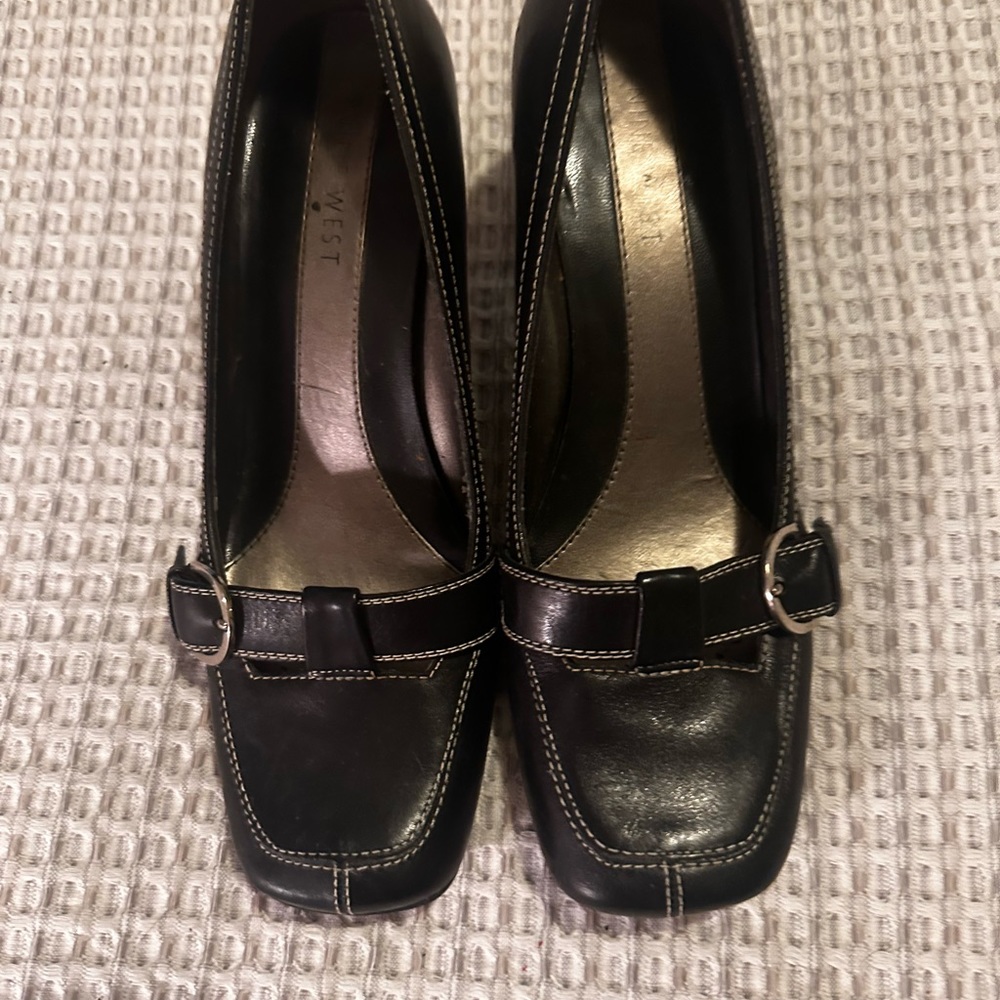 Nine West pumps black leather with white stitching.